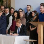 Seattle IT staff and members of the community stand behind Mayor Ed Murray as he signs an Executive Order in support of the City's new open data policy on February 26, 2016. Photo courtesy of Colin Wood.