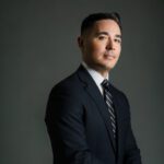 Rob Lloyd in a black suit and tie