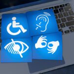 Blue disability icons on a keyboard.
