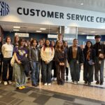 A group of students and Seattle city staff standing in front of the customer service center